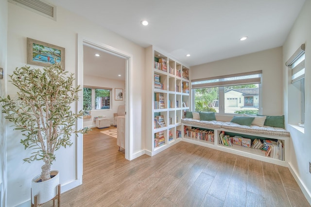 sitting room featuring recessed lighting, baseboards, light wood-type flooring, and visible vents