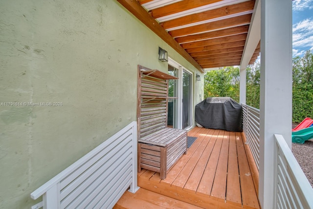 wooden terrace featuring area for grilling