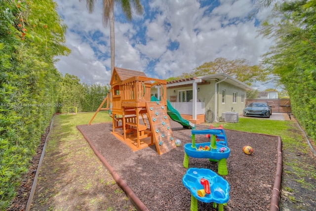 view of play area featuring a yard and central air condition unit