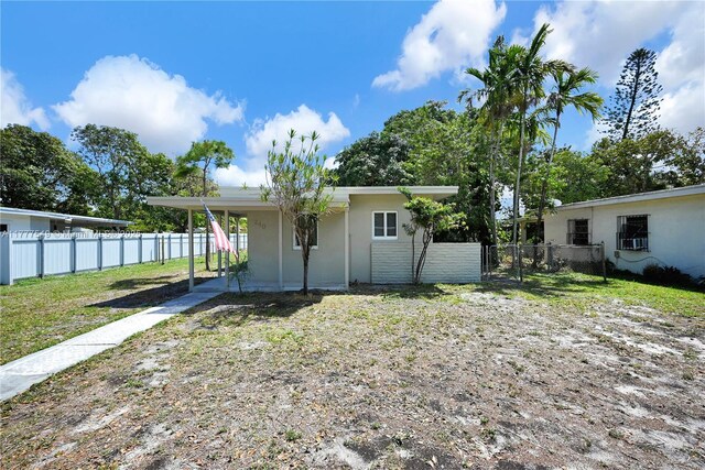 240 NW 127th St, North Miami, FL 33168 - rear view of property with fence, stucco siding, and an attached carport
