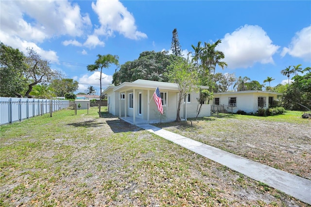 240 NW 127th St, North Miami, FL 33168 - view of front of property featuring fence and a front lawn
