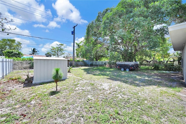 240 NW 127th St, North Miami, FL 33168 - view of yard with a storage unit, a fenced backyard, and an outdoor structure
