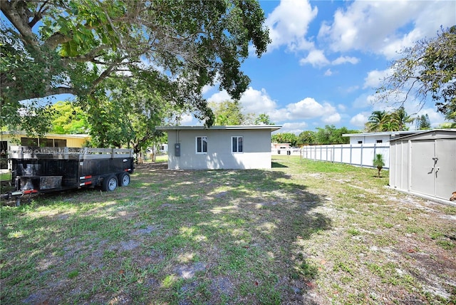 240 NW 127th St, North Miami, FL 33168 - view of yard with an outbuilding, a storage unit, and fence