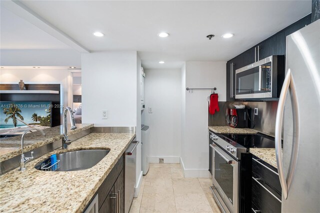 540 Brickell Key Dr Unit 1411, Miami, FL 33131 - kitchen with appliances with stainless steel finishes, a sink, recessed lighting, light stone countertops, and baseboards