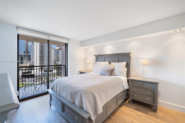 540 Brickell Key Dr Unit 1411, Miami, FL 33131 - bedroom with access to outside, light wood finished floors, baseboards, and a city view