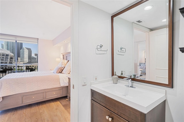 540 Brickell Key Dr Unit 1411, Miami, FL 33131 - bedroom featuring a sink, light wood-type flooring, access to exterior, expansive windows, and a view of city