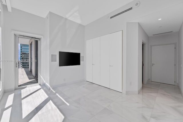 300 S Biscayne Blvd Unit Ph-3902, Miami, FL 33131 - unfurnished bedroom with a closet, access to exterior, visible vents, marble finish floor, and baseboards