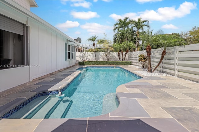 view of swimming pool with a fenced in pool, a fenced backyard, and a patio area