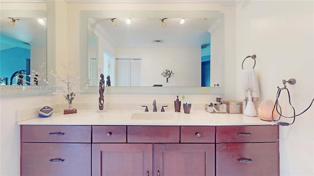 bathroom with vanity, ornamental molding, and visible vents