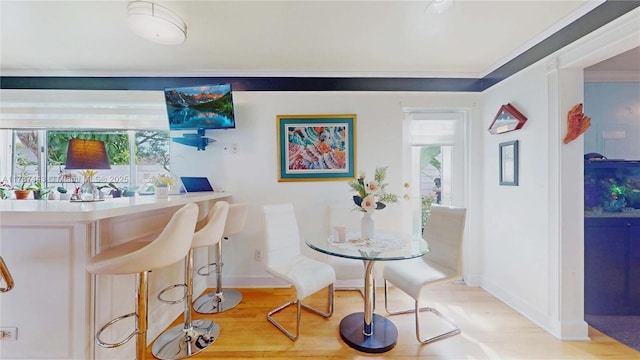 bar with baseboards, wood finished floors, and a wealth of natural light