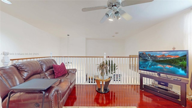 living area featuring a ceiling fan and wood finished floors