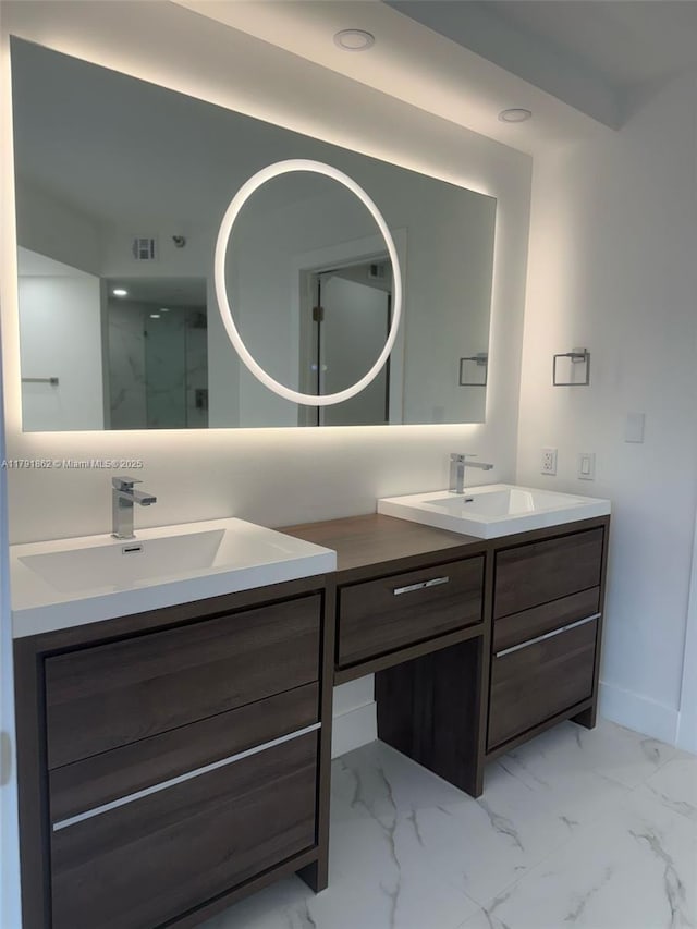 full bathroom with double vanity, walk in shower, and a sink