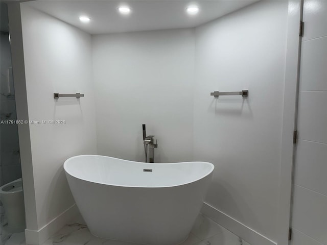 full bath featuring baseboards, recessed lighting, a freestanding bath, and marble finish floor