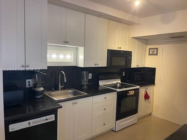 4400 Hillcrest Dr Unit 701B, Hollywood, FL 33021 - kitchen featuring range with electric stovetop, black microwave, dark countertops, a sink, and dishwashing machine