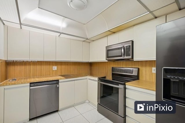 2500 Parkview Dr Unit 1816, Hallandale Beach, FL 33009 - kitchen with light tile patterned floors, white cabinetry, stainless steel appliances, and light countertops
