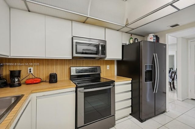 2500 Parkview Dr Unit 1816, Hallandale Beach, FL 33009 - kitchen with appliances with stainless steel finishes, light countertops, white cabinetry, visible vents, and light tile patterned flooring