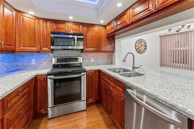 300 SW 130th Ter Unit 203B, Pembroke Pines, FL 33027 - kitchen featuring stainless steel appliances, a sink, light stone counters, light wood-type flooring, and recessed lighting