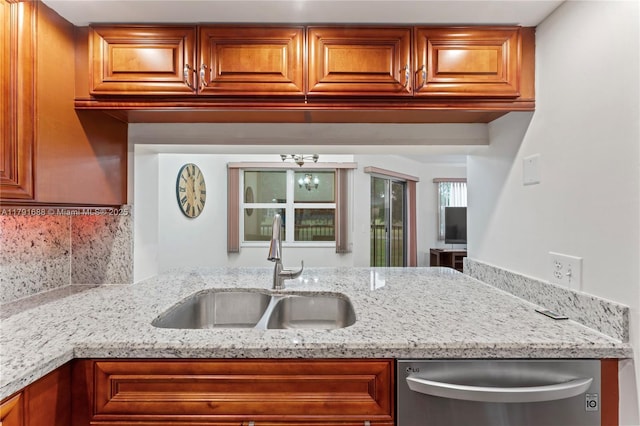 300 SW 130th Ter Unit 203B, Pembroke Pines, FL 33027 - kitchen with a sink, stainless steel dishwasher, light stone countertops, and brown cabinetry