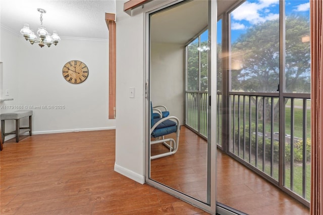 300 SW 130th Ter Unit 203B, Pembroke Pines, FL 33027 - corridor featuring a chandelier, ornamental molding, wood finished floors, and baseboards
