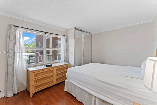300 SW 130th Ter Unit 203B, Pembroke Pines, FL 33027 - bedroom featuring crown molding, dark wood-type flooring, and a closet