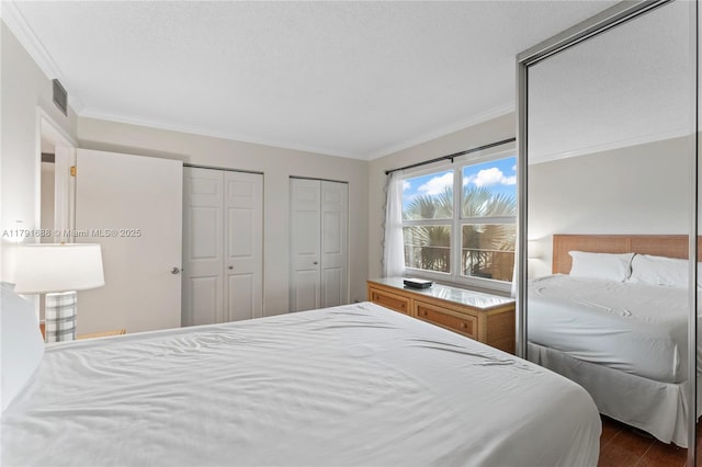 300 SW 130th Ter Unit 203B, Pembroke Pines, FL 33027 - bedroom featuring multiple closets, crown molding, and dark wood finished floors