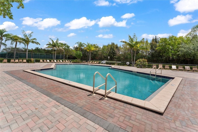 300 SW 130th Ter Unit 203B, Pembroke Pines, FL 33027 - community pool with fence, a patio area, and view of wooded area