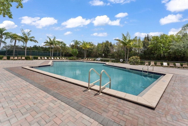 300 SW 130th Ter Unit 203B, Pembroke Pines, FL 33027 - community pool with fence, view of scattered trees, and a patio area