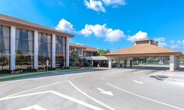 300 SW 130th Ter Unit 203B, Pembroke Pines, FL 33027 - uncovered parking lot with a gazebo