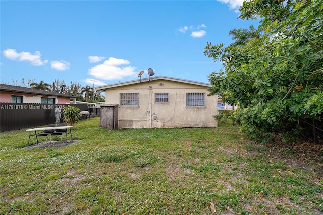 view of outbuilding featuring fence