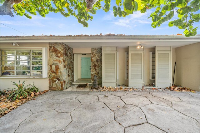 3030 SW 77th Ct, Miami, FL 33155 - property entrance featuring a patio area, stucco siding, and stone siding
