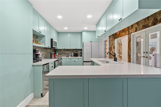 3030 SW 77th Ct, Miami, FL 33155 - kitchen featuring a sink, fridge, stainless steel range with electric cooktop, wine cooler, and backsplash