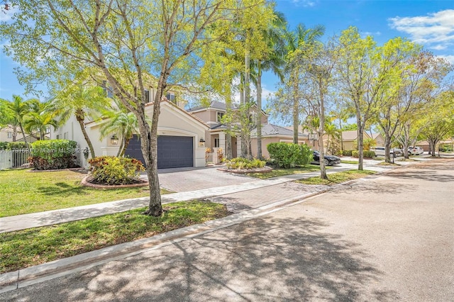943 Golden Cane Dr, Weston, FL 33327 - view of front of house featuring stucco siding, fence, a garage, driveway, and a front yard