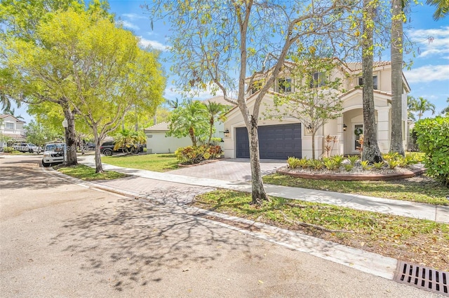 943 Golden Cane Dr, Weston, FL 33327 - view of front of home with a garage, stucco siding, and driveway