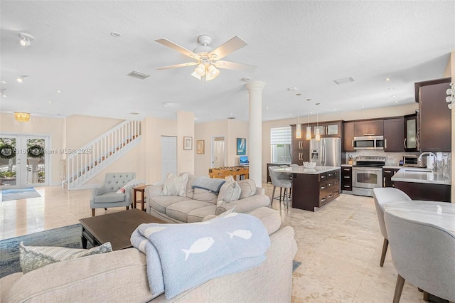943 Golden Cane Dr, Weston, FL 33327 - living room with stairs, visible vents, a ceiling fan, a textured ceiling, and french doors