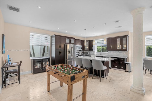 943 Golden Cane Dr, Weston, FL 33327 - recreation room featuring ornate columns, visible vents, and a healthy amount of sunlight
