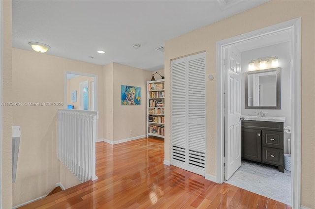 943 Golden Cane Dr, Weston, FL 33327 - hall featuring an upstairs landing, light wood-type flooring, baseboards, and a sink