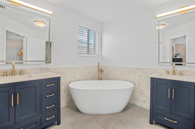943 Golden Cane Dr, Weston, FL 33327 - bathroom with wainscoting, two vanities, a freestanding tub, and a sink