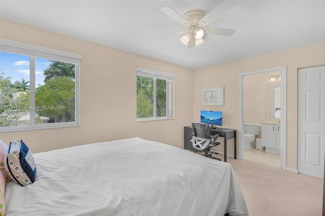 943 Golden Cane Dr, Weston, FL 33327 - bedroom featuring light colored carpet, ceiling fan, ensuite bathroom, and baseboards