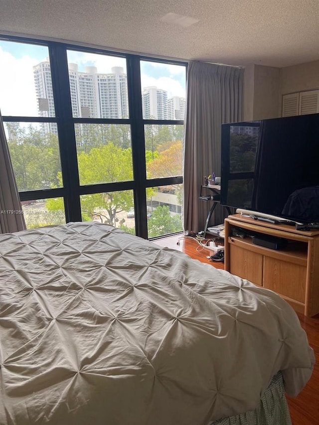 bedroom featuring a textured ceiling and wood finished floors