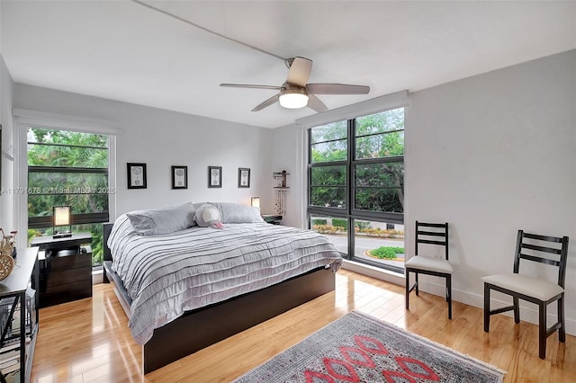100 Ocean Lane Dr Unit 301, Key Biscayne, FL 33149 - bedroom with light wood finished floors, a ceiling fan, and multiple windows