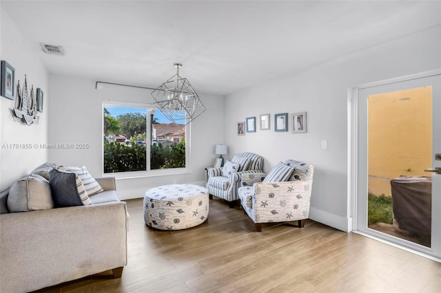 8323 NW 196th Ter, Hialeah, FL 33015 - living room with visible vents, wood finished floors, and a notable chandelier