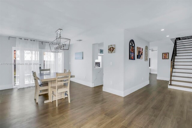 8323 NW 196th Ter, Hialeah, FL 33015 - dining area featuring dark wood finished floors, stairway, a notable chandelier, and baseboards