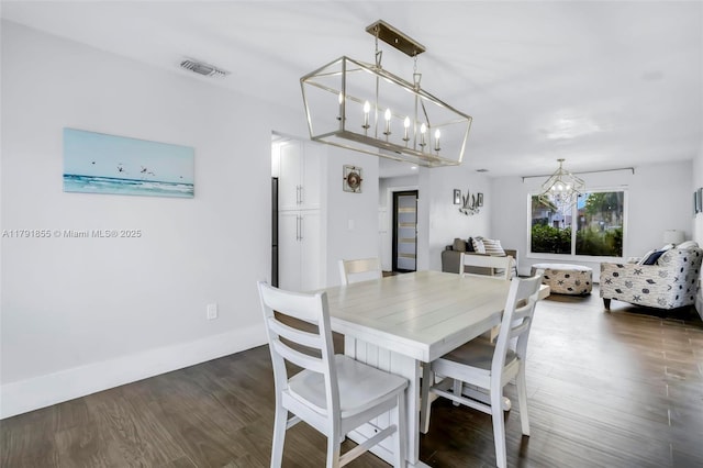 8323 NW 196th Ter, Hialeah, FL 33015 - dining space with visible vents, a notable chandelier, and dark wood finished floors