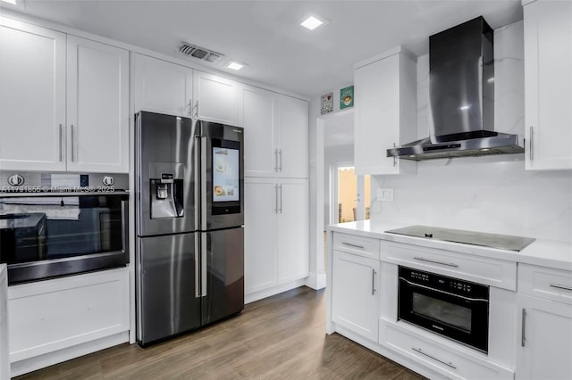 8323 NW 196th Ter, Hialeah, FL 33015 - kitchen with wall chimney exhaust hood, black electric cooktop, fridge with ice dispenser, and wall oven