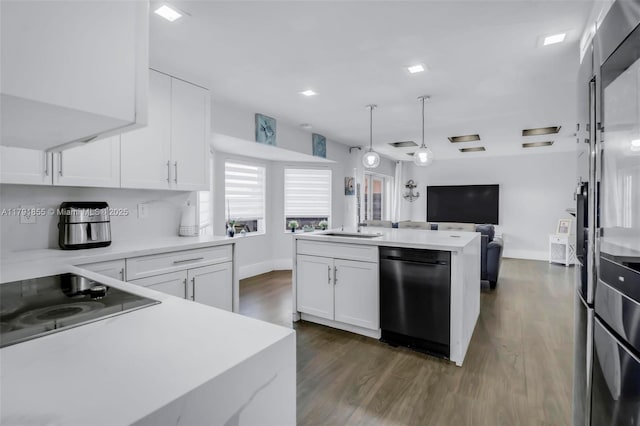 8323 NW 196th Ter, Hialeah, FL 33015 - kitchen featuring light countertops, white cabinets, black appliances, open floor plan, and dark wood-type flooring