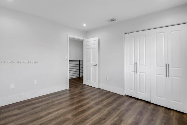 8323 NW 196th Ter, Hialeah, FL 33015 - unfurnished bedroom with dark wood-style floors, recessed lighting, a closet, visible vents, and baseboards