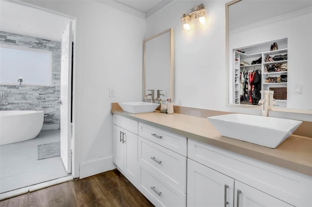 8323 NW 196th Ter, Hialeah, FL 33015 - full bathroom featuring double vanity, wood finished floors, a freestanding bath, and a sink