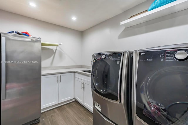 8323 NW 196th Ter, Hialeah, FL 33015 - laundry room with wood finished floors, washer and clothes dryer, cabinet space, and recessed lighting