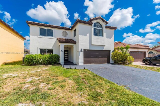 8323 NW 196th Ter, Hialeah, FL 33015 - mediterranean / spanish-style home featuring a tile roof, decorative driveway, stucco siding, a front lawn, and a garage