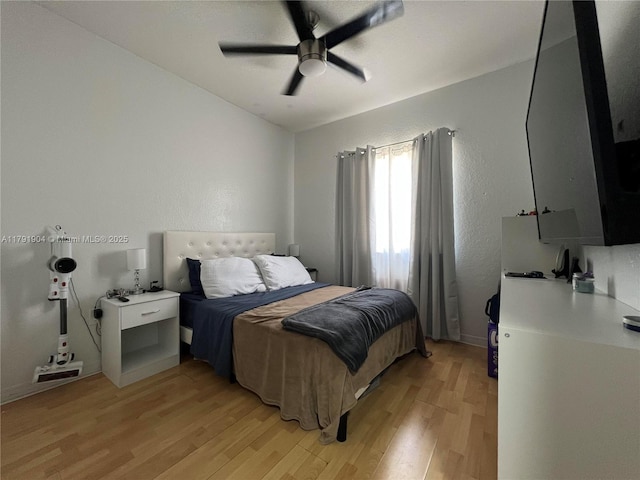 bedroom featuring light wood-style floors and a ceiling fan